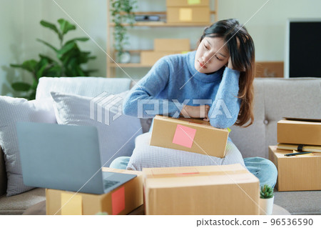 Starting small business entrepreneur of independent Asian woman showing her face worried about the sales of her business not reaching the target set. SME concepts. Starting small business entrepreneur of independent Asian woman showing her face worried about the sales of her business not reaching the target set. SME concepts. 96536590