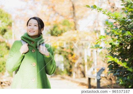 woman in coat and rucksack 96537187