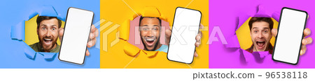Three excited young multicultural men holding three big cell phones 96538118
