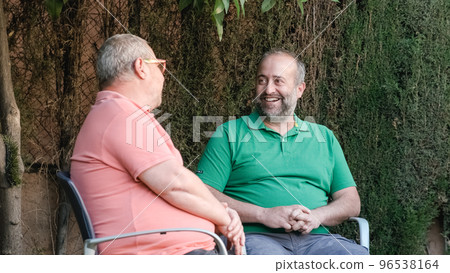 Cheerful men chatting on street 96538164