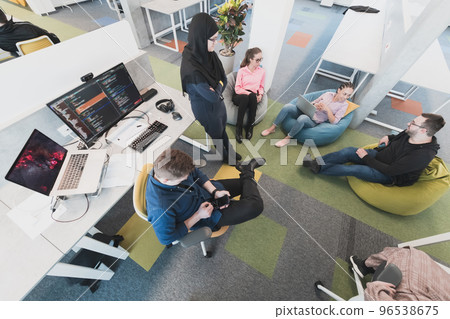 Top view photo of collaborative process of multicultural skilled young business team during brainstorming meeting in office.Diverse group of young people dressed in formal wear cooperating on Top view photo of collaborative process of multicultural skilled young business team during brainstorming meeting in office.Diverse group of young people dressed in formal wear cooperating on 96538675