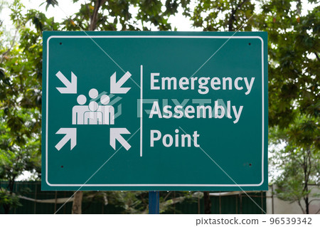 Emergency assembly point sign in the park. Emergency assembly point sign in the park. 96539342
