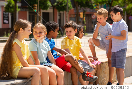 Group children are talking about play on walk in the park Group children are talking about play on walk in the park 96539343