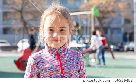 Portrait of positive little girl at the playground Portrait of positive little girl at the playground 96539498