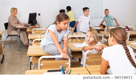 Kids pupils talking during recess between lessons Kids pupils talking during recess between lessons 96539651