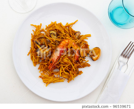 Traditional spanish seafood dish fideua with aioli sauce in restaurant 96539671