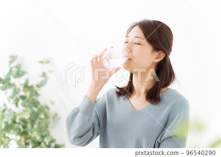 A woman drinking water A woman drinking water 96540290