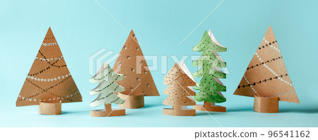 Paper Fur Tree for Happy new year 2023 Merry Christmas party. Easy crafts for kids on blue background, simple diy idea from toilet roll tube, recycle concept, copy space 96541162