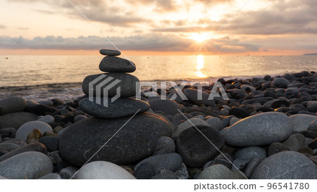 Stack of zen stones on the beach at sunset, beautiful seascape. Made of stone tower as rest balance vacation concept. 96541780