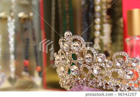 Crystal Tiara on Dressing Table Close up with Jewelry in Background Crystal Tiara on Dressing Table Close up with Jewelry in Background 96542207