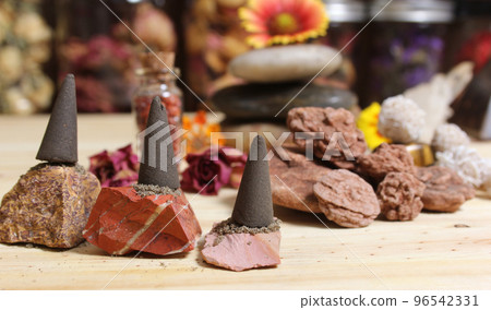 Incense Cones and Desert Rose Rocks on Meditation Table 96542331