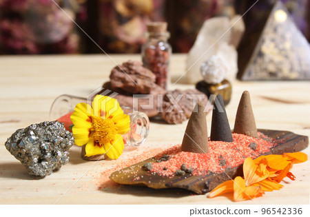 Incense Cones on Stone Slab With Crystals and Flowers 96542336