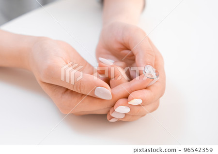 Woman holding contact lens on the finger tip Woman holding contact lens on the finger tip 96542359