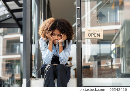 black woman waiter of street cafe is waiting for clients, customersm she is bored, no people in their cafe. small business owner. black woman waiter of street cafe is waiting for clients, customersm she is bored, no people in their cafe. small business owner. 96542436