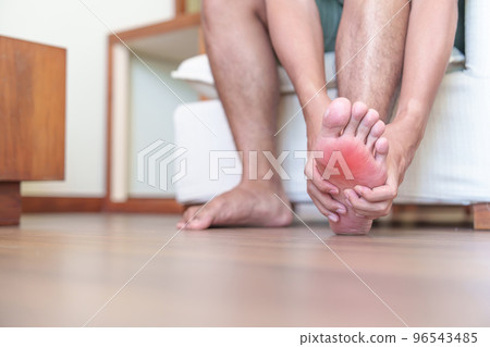 man having barefoot pain due to Plantar fasciitis and bunion toes or blister due to wearing narrow shoes and waking or running longtime. Health and medical concept man having barefoot pain due to Plantar fasciitis and bunion toes or blister due to wearing narrow shoes and waking or running longtime. Health and medical concept 96543485