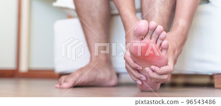man having barefoot pain due to Plantar fasciitis and  bunion toes or blister due to wearing narrow shoes and waking or running longtime. Health and medical concept 96543486