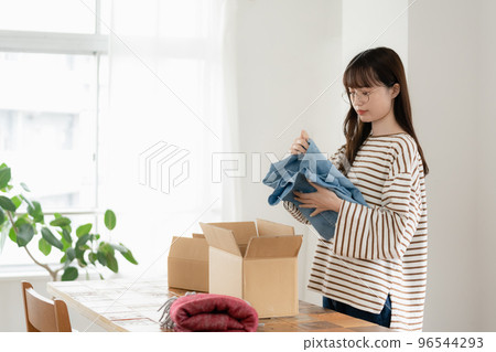 Young woman disposing of unnecessary items Young woman disposing of unnecessary items 96544293