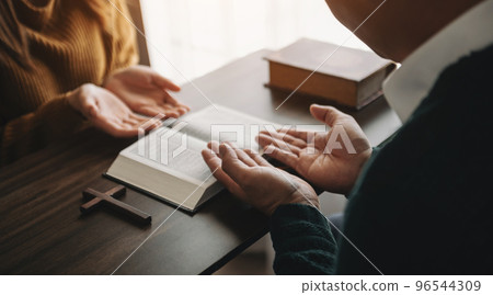 Christians are congregants join hands to pray and seek the blessings of God... 96544309