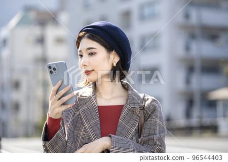 一名 30 歲左右的女性正在看著智能手機屏幕 一名 30 歲左右的女性正在看著智能手機屏幕 96544403