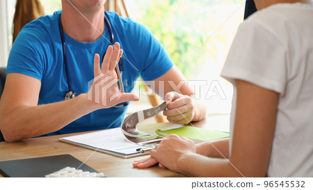 Male practitioner looking at description of ultrasound shots of calming down patient Male practitioner looking at description of ultrasound shots of calming down patient 96545532