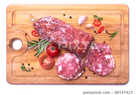 Sliced Smoked dry Salami sausage on wooden cutting board isolated on white background 96547423