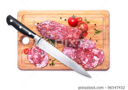 Sliced Smoked dry Salami sausage on wooden cutting board isolated on white background 96547432