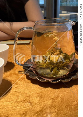 Relax while watching the leaves open like flowers in a cup of tea 96548963