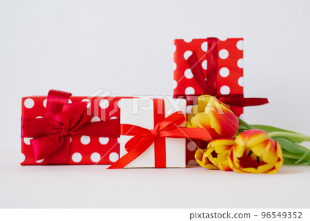 A bouquet of red spring flowers tulips and red gift boxes. Valentine Day and Mother Day 96549352