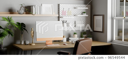 Modern home working room with computer and accessories on wood table against grey wall Modern home working room with computer and accessories on wood table against grey wall 96549544
