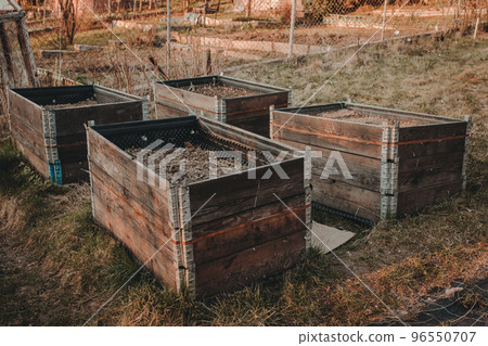 pallet collar raised beds in garden. Permaculture concept 96550707