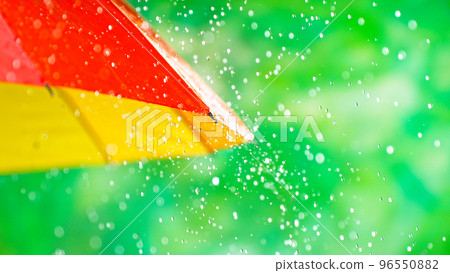 Rain drops on colored umbrella, freeze motion 96550882