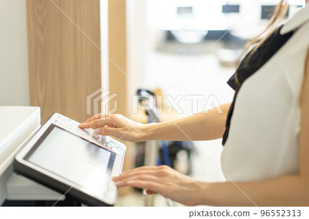 Hand of a woman who operates a copier in the office [parts cut] 96552313