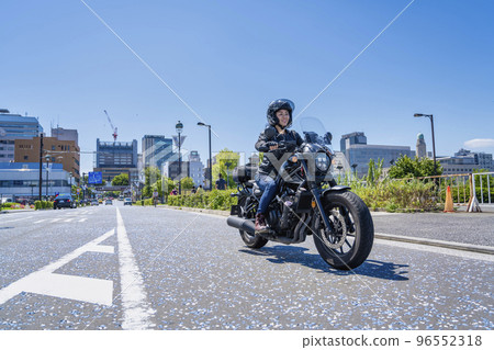 A female rider touring Yokohama on a cruiser bike A female rider touring Yokohama on a cruiser bike 96552318