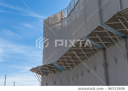 Morning glory and scaffolding removal at a construction site Morning glory and scaffolding removal at a construction site 96552606