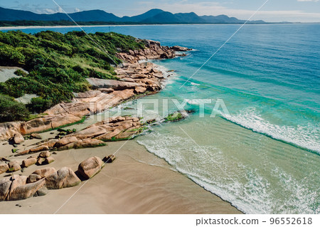 Beach and blue ocean in Brazil. Aerial view of tropical beach in Florianopolis Beach and blue ocean in Brazil. Aerial view of tropical beach in Florianopolis 96552618