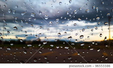 Rain water drops cover on the glass with blur background 96553386