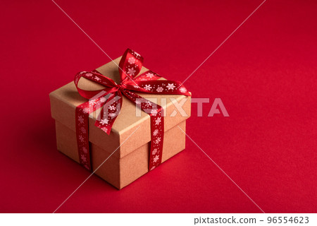 Christmas gift box with red bow on red background. Christmas gift box with red bow on red background. 96554623