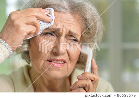 Elderly woman holding her hand to her throat. Disease Elderly woman holding her hand to her throat. Disease 96555579