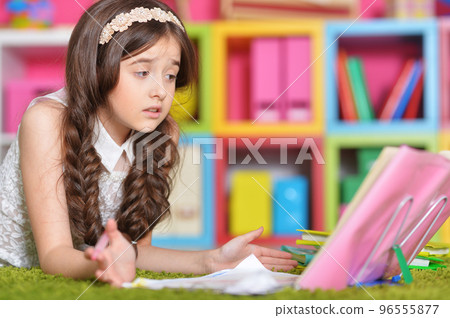Portrait of cute little girl study at home  96555877
