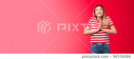 Dreamy enthusiastic attractive tender modern asian blond girl praying believe dreams come true, ask Lord favour, supplicating, hold palms together make wish stand red background Dreamy enthusiastic attractive tender modern asian blond girl praying believe dreams come true, ask Lord favour, supplicating, hold palms together make wish stand red background 96556066