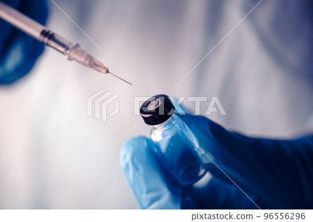 Medical hand glove blue vial vaccine hypodermic needle syringe injection treatment. Lab test immunization and vaccination concept. drug insulin care prevention diabetes disease hospital. Healthcare Medical hand glove blue vial vaccine hypodermic needle syringe injection treatment. Lab test immunization and vaccination concept. drug insulin care prevention diabetes disease hospital. Healthcare 96556296