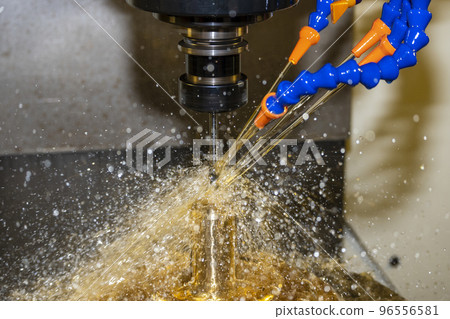 The CNC milling machine cutting the  mold parts with oil coolant method. 96556581
