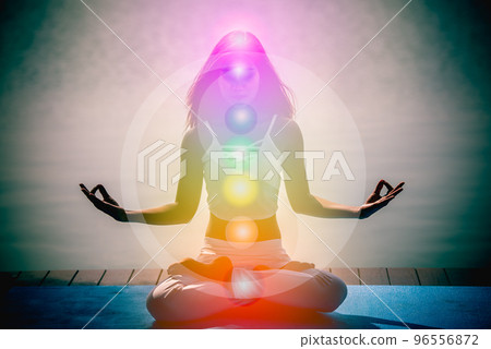 Young aura woman in yoga meditation with nature seven chakras and Yin Yang symbols. 96556872