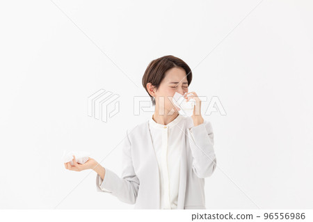 Woman wiping with a tissue White background Woman wiping with a tissue White background 96556986
