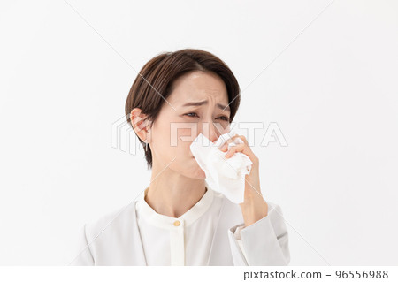 Woman wiping with a tissue White background 96556988