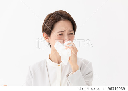 Woman wiping with a tissue White background 96556989