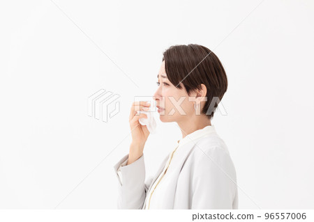 Woman wiping with a tissue White background 96557006
