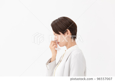 Woman wiping with a tissue White background 96557007