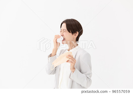 Hay fever mask woman wiping with tissue white background Hay fever mask woman wiping with tissue white background 96557059