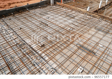 MELAKA, MALAYSIA -JULY 2, 2022: Steel reinforcement bars are arranged according to the structural engineer's design. The steels are tied together using a small steel wire. MELAKA, MALAYSIA -JULY 2, 2022: Steel reinforcement bars are arranged according to the structural engineer's design. The steels are tied together using a small steel wire. 96557177